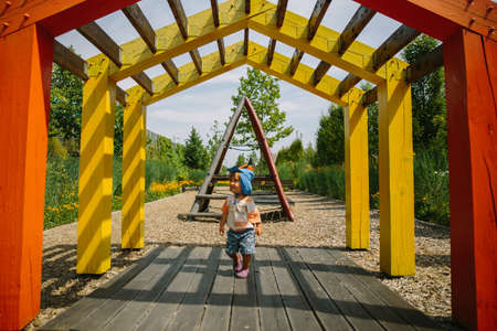 Adorable little 1-2 year old toddler boy having fun on playground in Krakow, Polandの写真素材