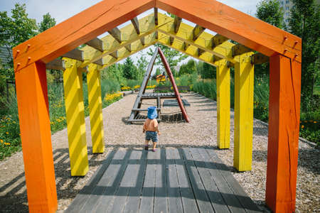 Adorable little 1-2 year old toddler boy having fun on playground in Krakow, Polandの写真素材