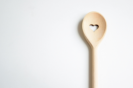 Wooden spoon with heart on white backgroundの写真素材