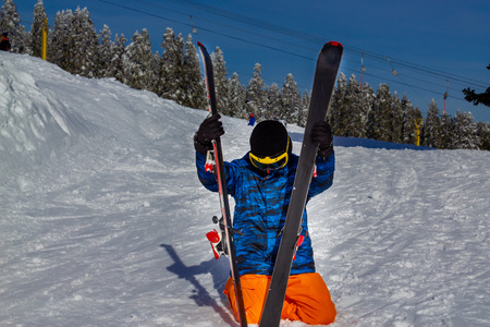 Young man sitting on snowの写真素材