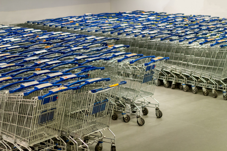Supermarket shopping carts lined up emptyの写真素材