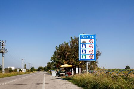 Pazarkule, Edirne / Turkey - October 02 2019: Pazarkule border entrance road crossing Turkey national traffic sign boardのeditorial素材