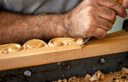 Carpenter working on wooden furniture with hand carving. Wood carving art with hand tools