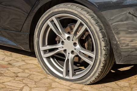 Burst flat car tire wheel. on a car
