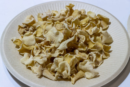 White Fungus uncooked mushroom in white plate isolated background