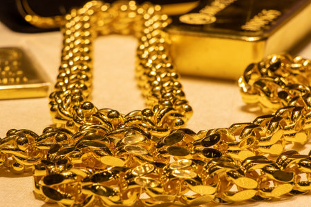 Thick and heavy gold chain jewelry and gold bars. Wealth, luxury and prosperityの写真素材