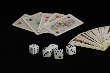 The dice and playing cards on black backgroundの写真素材