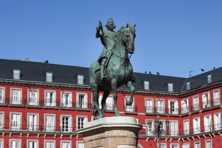 King Felipe III Monument with a building in the background at Plaza Mayor, the main town square. 03/15/2017 Madrid, Spain.のeditorial素材