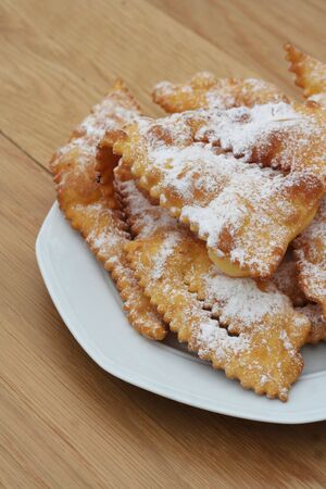 Italian carnival pastry on wooden background. Traditional Crostoli or chiacchere, lies or cenci.の写真素材