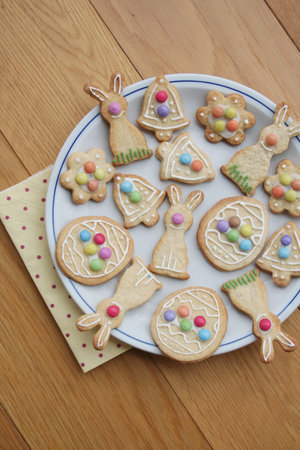 Easter glazed cookies in shape of egg, bunny, flower on a wooden background