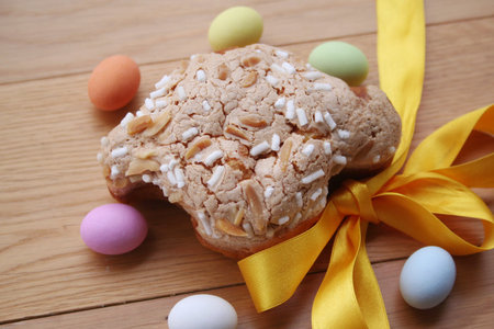 Sweet Easter cake named Easter Pastry with Easter eggs. Italian traditional pastry on wooden table