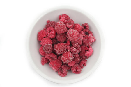 Frozen raspberries isolated on white background