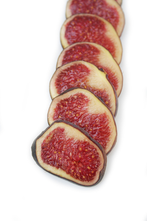 Fresh ripe fig slices in a row isolated on white backgroundの写真素材