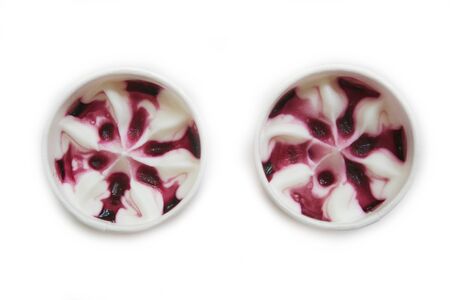 Cream and cherry icecream in a cup isolated on white backgroundの写真素材