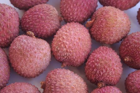 Fresh ripe lychee or lychee fruits on white background. Lychee chinensis fruitの写真素材