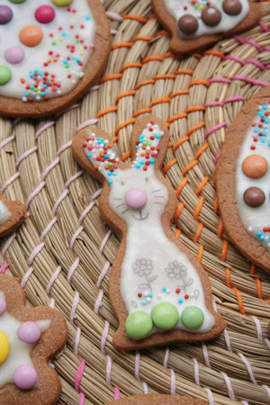 Homemade Easter cookies in shape of bunny and Easter eggs on wooden background. Springtime...