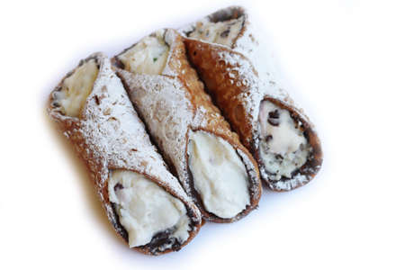 Traditional italian pastry called Cannolo with candied fruit and chocolate isolated on white backgroundの写真素材