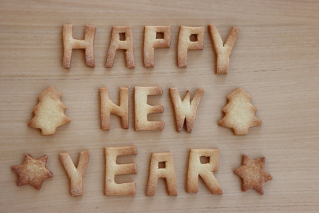 Happy New year cookies. Baked cookie letters on wooden tableの写真素材