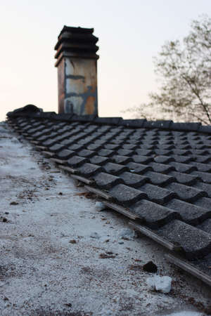Removing Gray cement roofing tiles damaged by weather on top of a house in Italyの写真素材