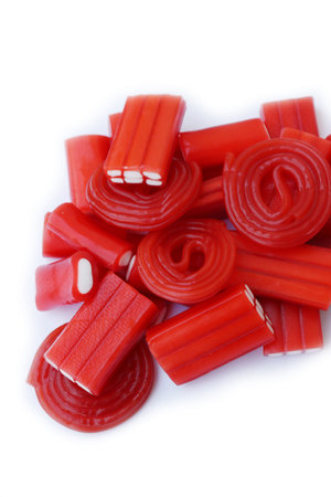 Various sweet red candies isolated on white backgroundの写真素材