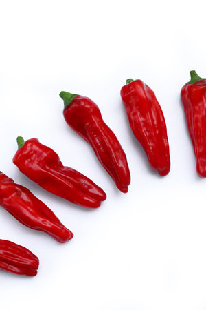 Red sweet long peppers isolated on white background. Summer vegetables. Capsicum annuum