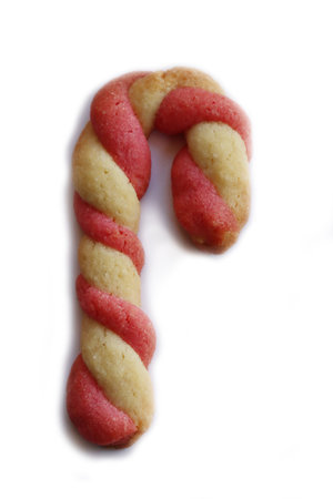 Christmas cookies in shape of a candy cane isolated on white backgroundの写真素材