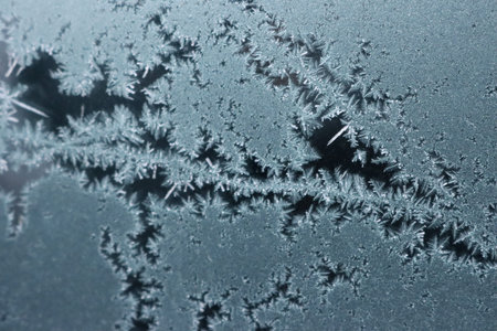 Abstract background with decorative ice crystals pattern on black matte background
