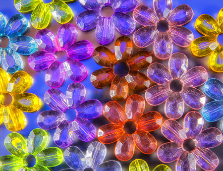 Colored glass transparent flowers in a colored background on whiteの写真素材