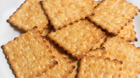 Macro photo of brown dietary low-calorie crispy cereal cracker with sesame dressing close-up on a...