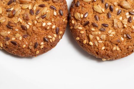 Macro photo of brown dietary low-calorie fitness cereal biscuits with sprinkling closeup on white background.の写真素材