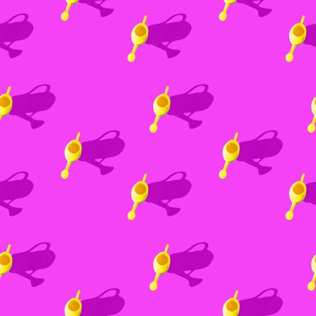 Photo seamless pattern yellow watering can for watering flowers with shadows on a colored...