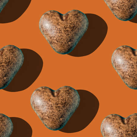 Photo seamless pattern of chocolate gingerbread in the shape of dark brown color with shadows on a colored background.の写真素材