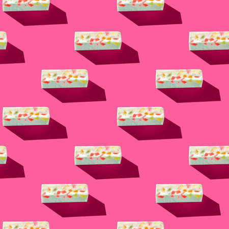 Photo in the form of a seamless pattern. Gray pastille with colored splashes with shadows on a colored pink background. High quality photoの写真素材