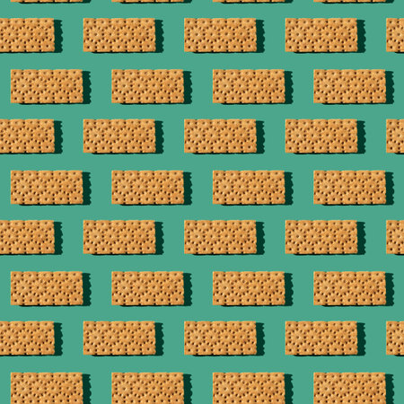 Photo in the form of a seamless pattern. Orange color loafs for healthy food with shadows on a...