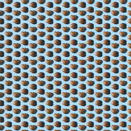 Photo in the form of a seamless pattern. Chocolate gingerbread in the shape of a heart of dark brown...