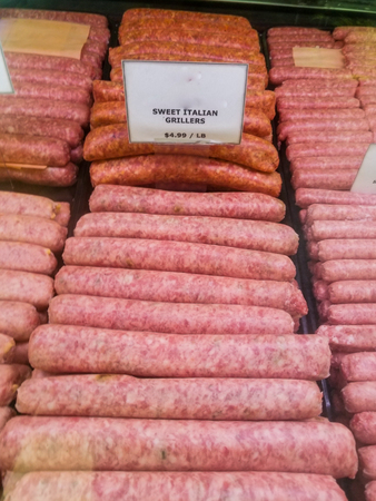 Sausage links in a butchers case at a farmers marketの写真素材