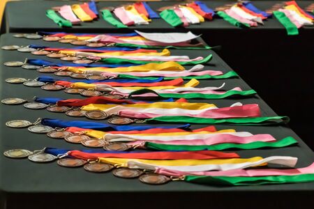 Medals on a table waiting to be handed out at a sports event.の写真素材