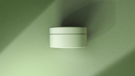 3d rendering of a cream jar with shadow on a green wallの写真素材