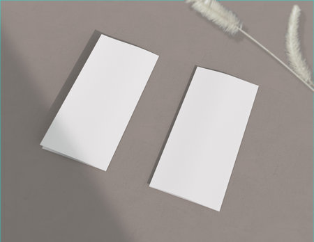 Showcase your content with this 3D illustration of a blank brochure mock-up, featuring a simple and harmonious background. Roll-Fold 297mm 210mm size.の写真素材