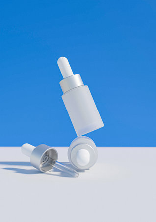 Cosmetic bottle with pipette on blue background. 3D rendering. A cosmetics mock-up image. Serum product mock up image.の写真素材