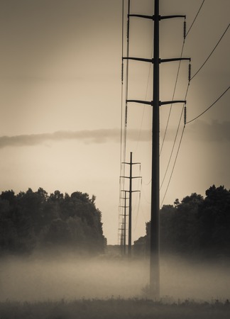Power Poles at Sundown Geound Fog In Distanceの写真素材