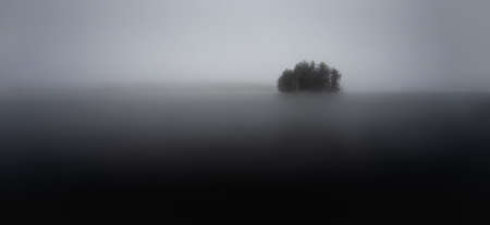 Misty morning sunrise small island in lakeの写真素材