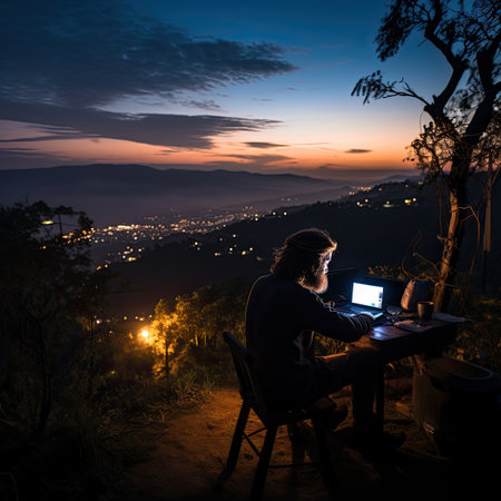 Silhouette of young woman working with laptop on the mountain at nightの素材