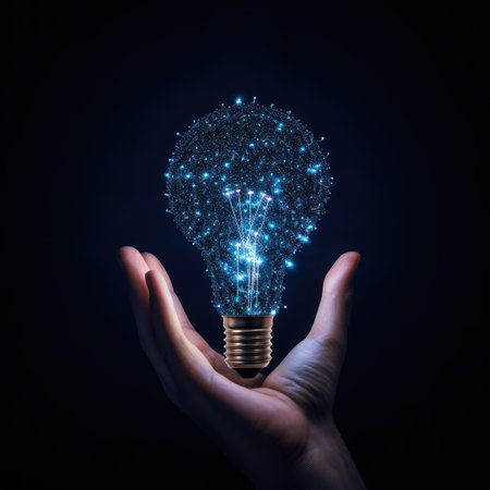 Glowing light bulb in hand on dark background. Idea concept.の素材