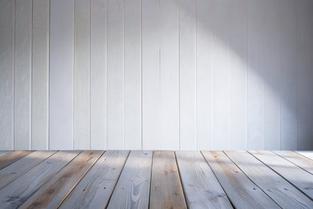 Wooden floor and white wall with sunlight from window for background.の素材