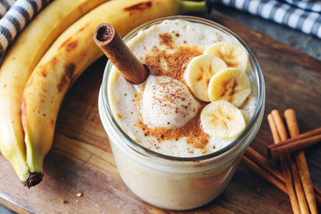 Creamy banana smoothie topped with cinnamon and nuts.の素材