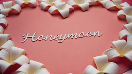 Honeymoon Text With Petals on a Romantic Pink Backgroundの素材