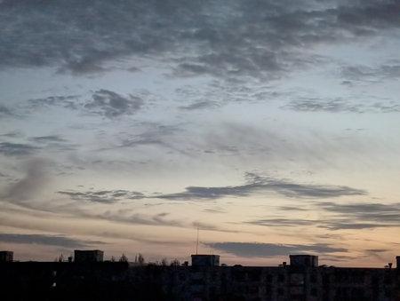 Sunset in the city. Clouds over the city. Sky background.の写真素材