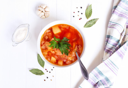 Red borscht soup bowl, sour cream, top view, on wooden background. Towelの写真素材