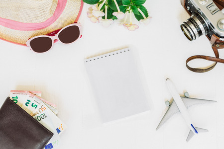 White background, Travel, airplane, camera, straw hat, purse with bank cards and money, notebook, top view.の写真素材